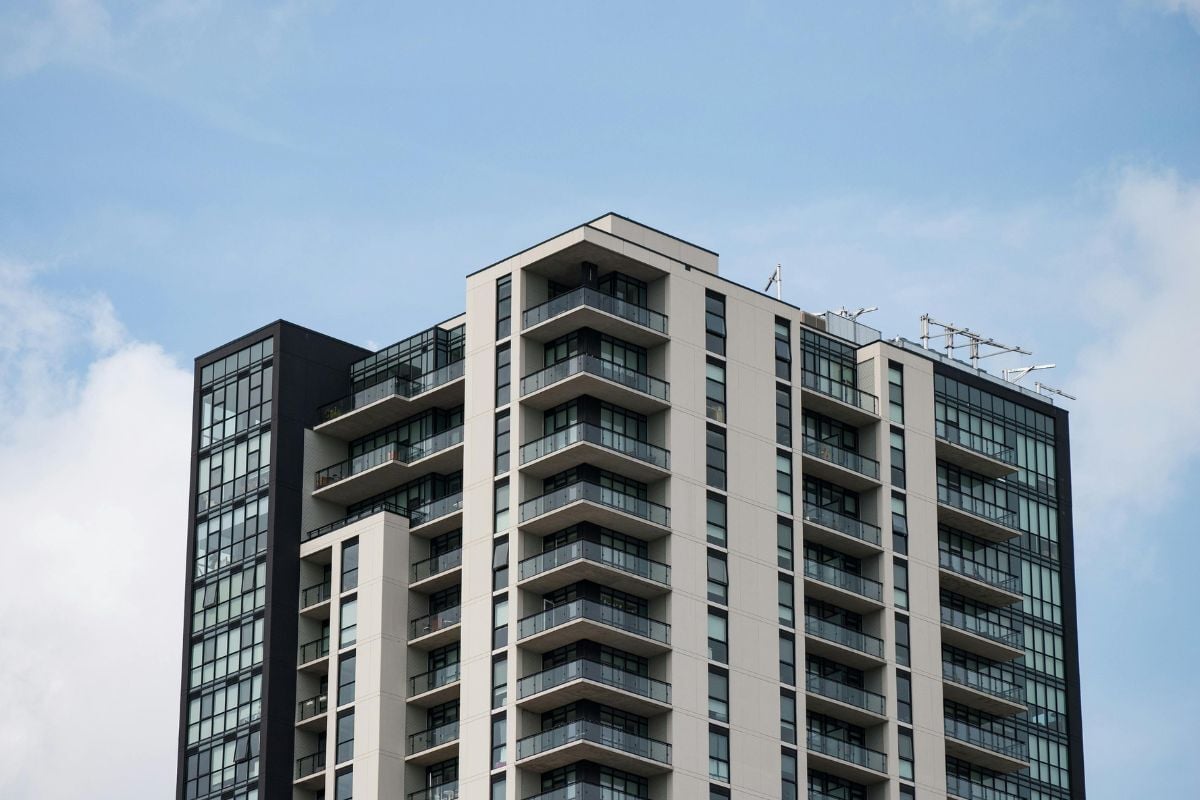 The exterior of a new condo building on a clear day