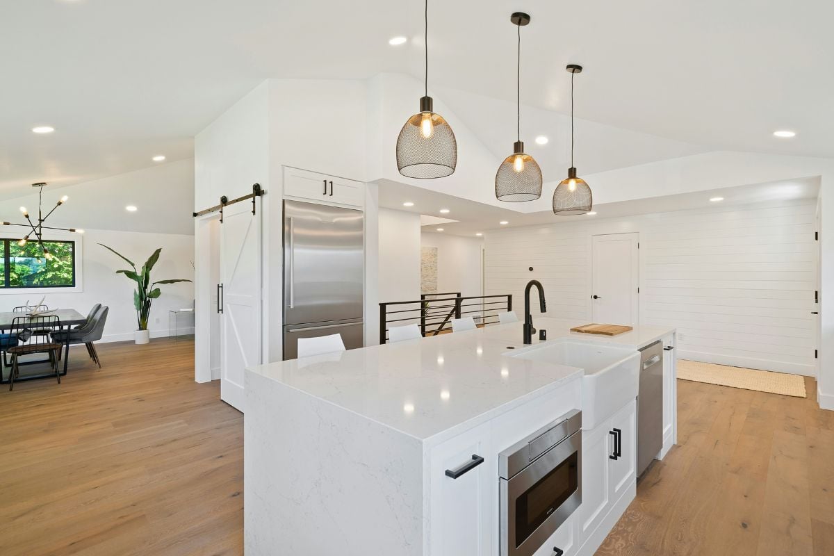 The interior of a new condo with marble countertops, stainless steel appliances and an open concept layout 