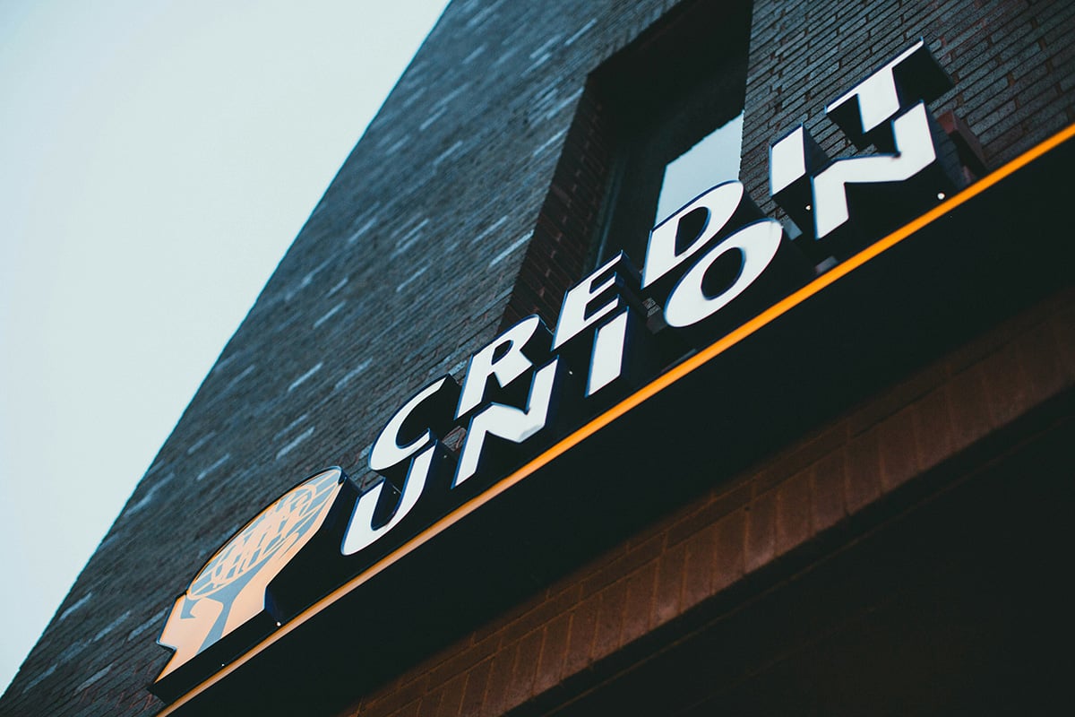 A close up view of a sign for a credit union, taken from below 