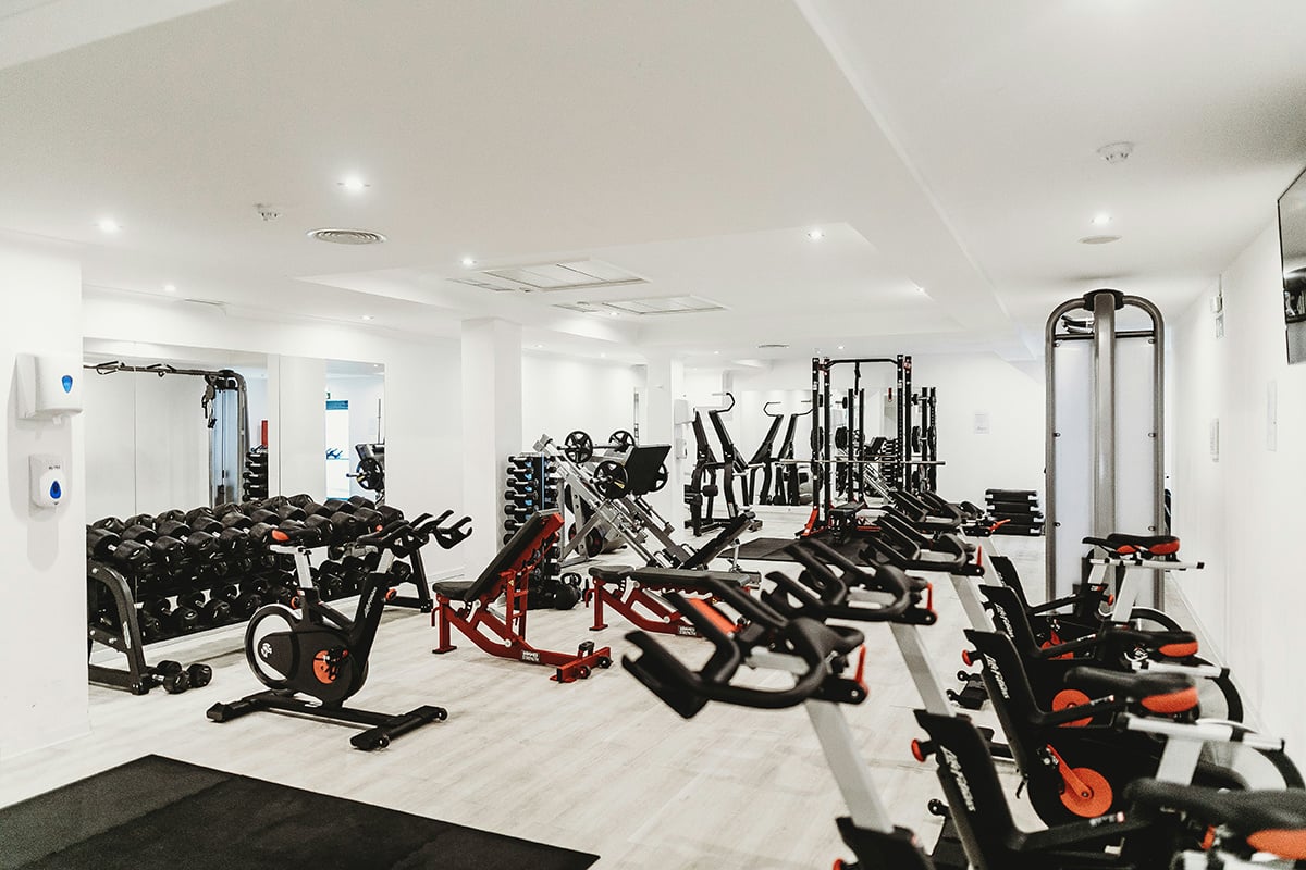 A private gym with exercise equipment and free weights