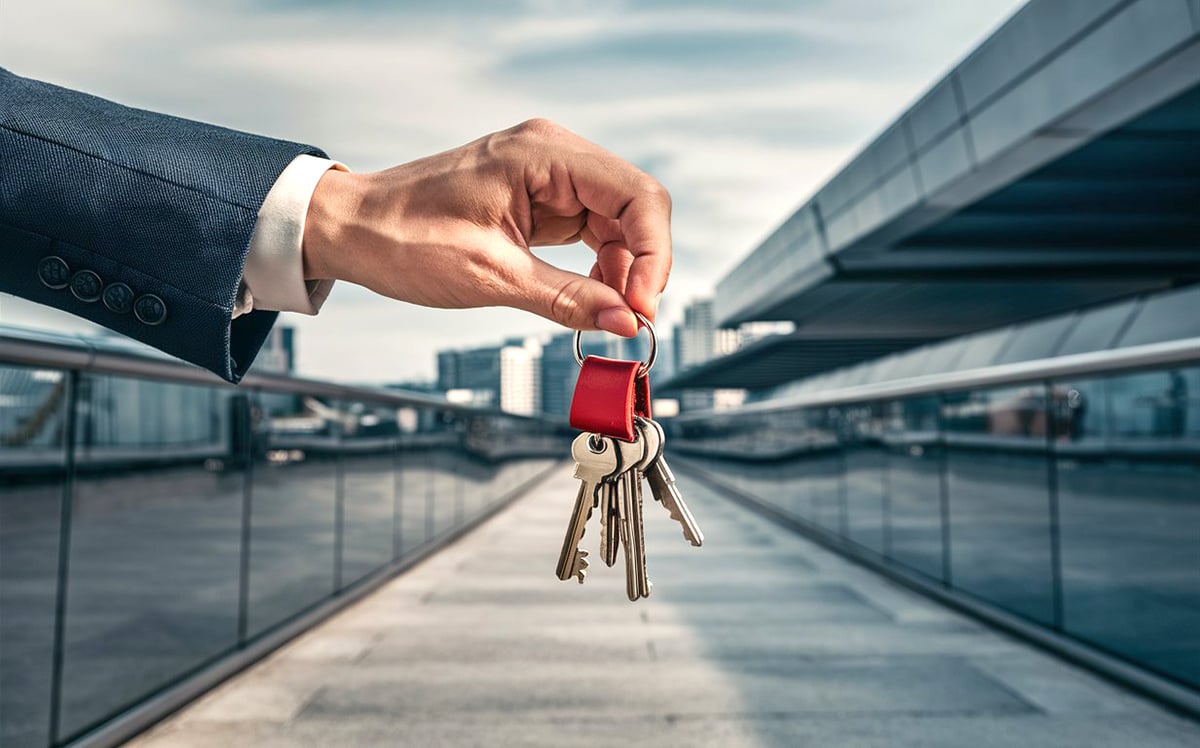 A person holding the keys to their new NYC investment property
