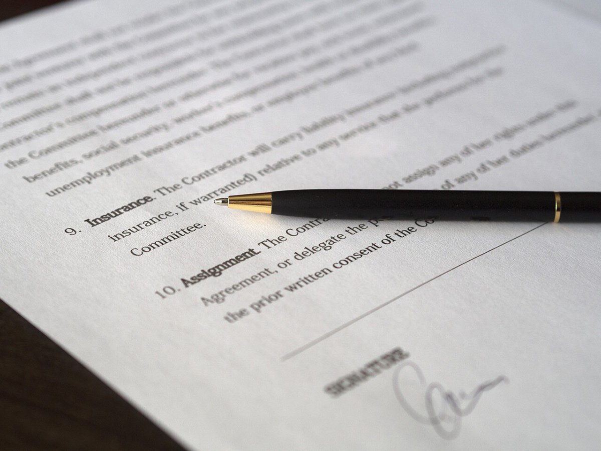Person with a pen and a contract 